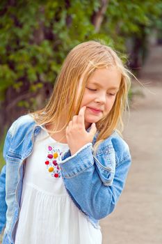 Cute girl with blond long hair in summer