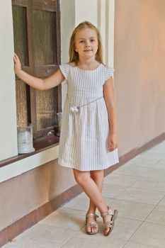 Cute girl with blond long hair and blue eyes