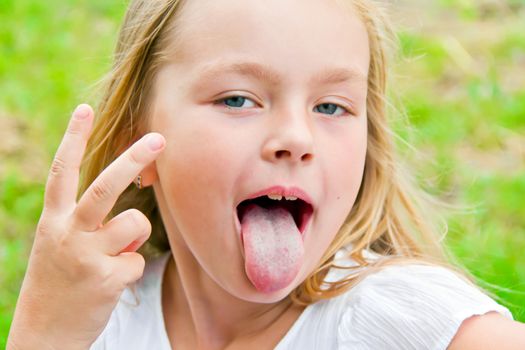 Portrait of cute girl with put out tongue