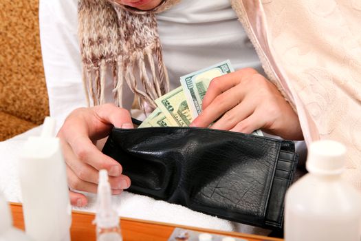 Sick Person checking the Wallet with the Pills on foreground closeup