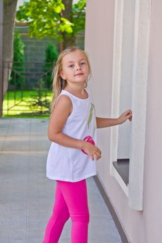 Cute girl with blond long hair and blue eyes