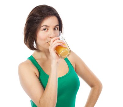 Portrait of a young woman drinking an orange juice, isolated on white