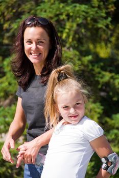 Photo of smiling mother and daughter in summer