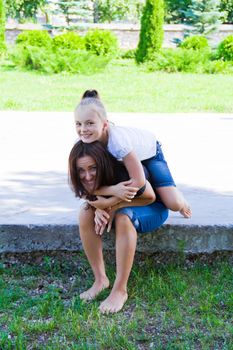 Photo of mother and daughter playing in summer