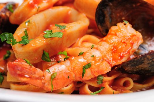 Seafood mixed saute with shrimps, mussels and squids, detailed macro shot