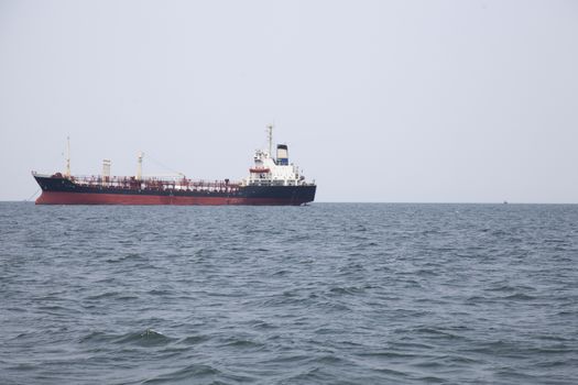 Large cargo ship Boats moored in the sea to make sense compared to the coast.