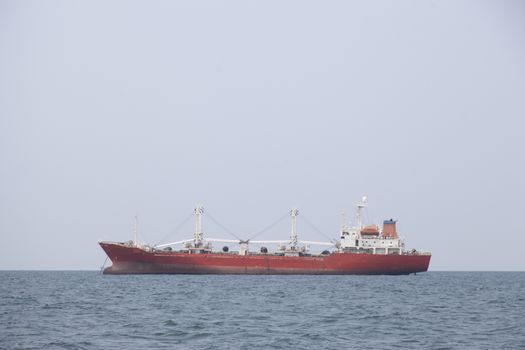 Large cargo ship Boats moored in the sea to make sense compared to the coast.