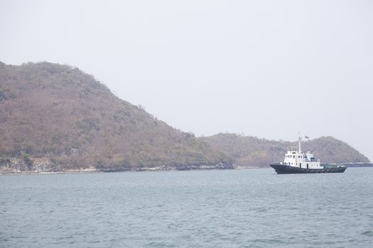 Large cargo ship Boats moored in the sea to make sense compared to the coast.