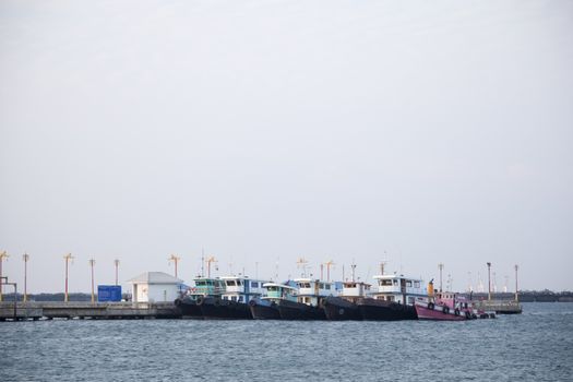 Large cargo ship Boats moored in the sea to make sense compared to the coast.