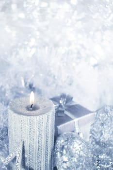 Beautiful shiny silver christmas decor and burning candle