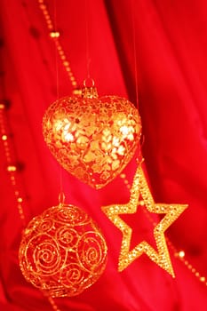Golden christmas decor on red fabric background