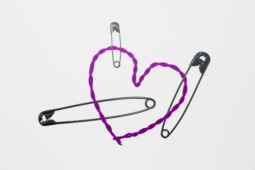 broken heart fixed with safety pins