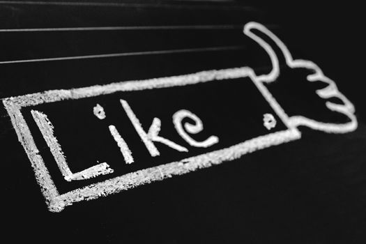 Thumb Up Sign, like word handwritten on black chalkboard