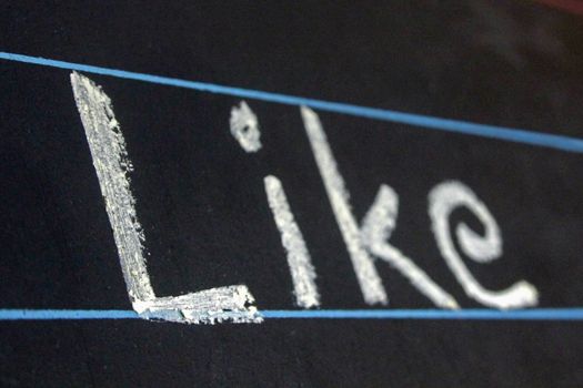 like word handwritten on black chalkboard