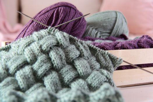 wool with needles in cage 