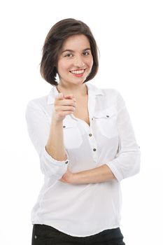 Portrait of a young brunette pointing in front of her,  isolated on white