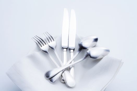 silverware - closeup of elegant knife fork and spoon on white cloth