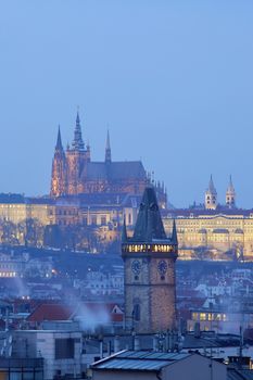 prague - old town city hall tower and hradcany castle at dusk
