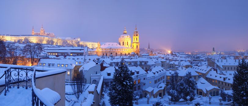 prague - panorama of hradcany castle and st. nicolaus church in winter
