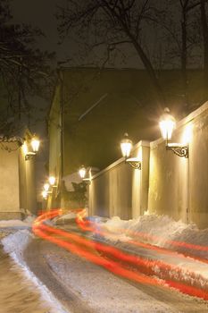prague - narrow street at hradcany with gas lanterns in winter