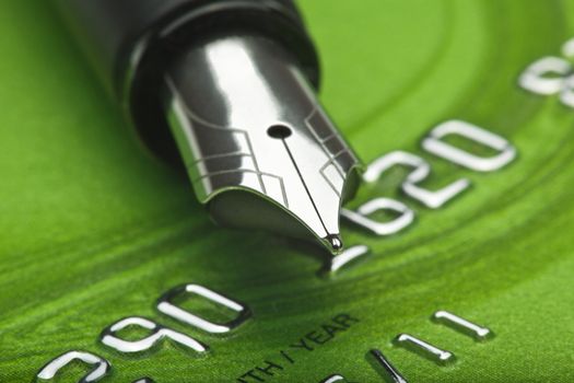 shopping - extreme closeup of a fountain pen and credit card