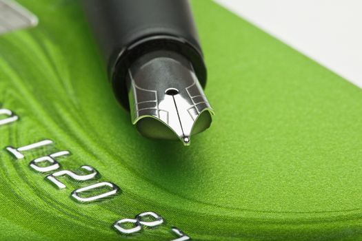 shopping - extreme closeup of a fountain pen and credit card