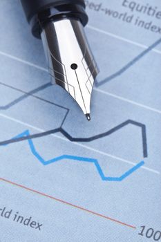 extreme closeup of a fountain pen and charts