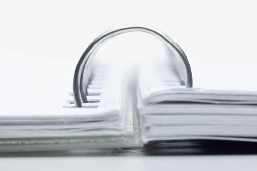 extreme closeup of a spiral notebook on white