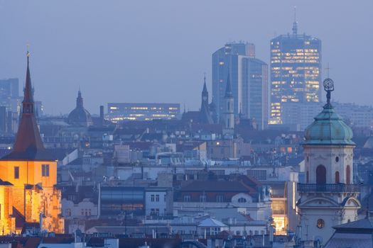 prague - towers of the old town and office highrises at dusk