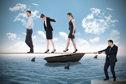 Young businessman pulling a tightrope for business people against sharks circling small boat in the ocean