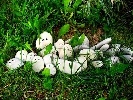    decorative stone lies in green herb