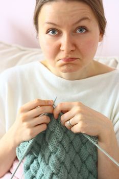 sad young woman can not knitting 