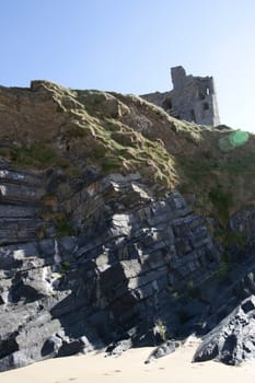 old historic castle on a cliff edge over the beach in Ballybunion county Kerry Ireland