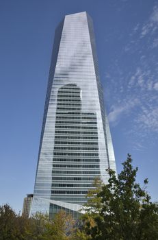 Reflection of the PwC Tower into the Crystal tower Space in the Four Towers Business Area, Madrid, Spain. The Crystal tower was designed by Pelli and the  PwC Tower by  Carlos Rubio Carvajal and Enrique Alvarez-Sala Walter.