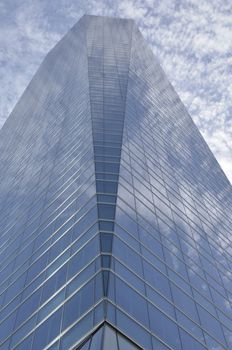 Clouds reflected in the Crystal Tower in the Four Towers Business Area, Madrid, Spain.  
The Crystal tower was designed by Pelli.