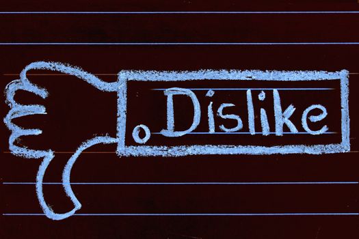 Dislike word handwritten on black chalkboard