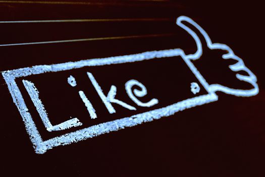 Thumb Up Sign, like word handwritten on black chalkboard