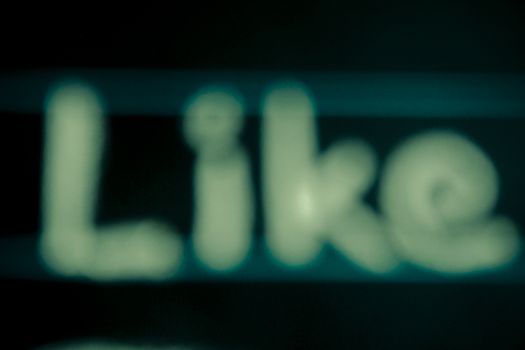blur image of like word handwritten on black chalkboard