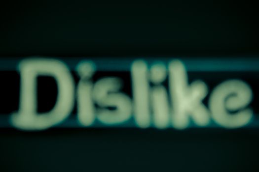 blur image of dislike word handwritten on black chalkboard