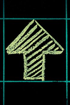 up side arrow sign handwritten on black chalkboard