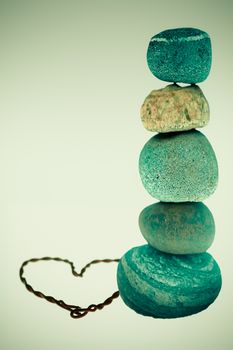 Pile of pebble Stones with heart made of wires