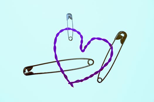 broken heart fixed with safety pins