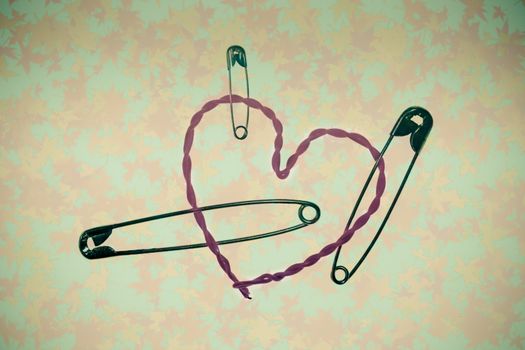 broken heart fixed with safety pins