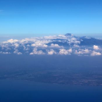 Soft clouds over view from airplane flying