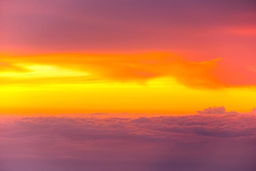 Sunset with clouds over view from airplane flying