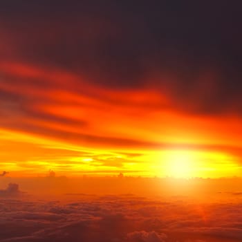 Sunset with clouds over view from airplane flying