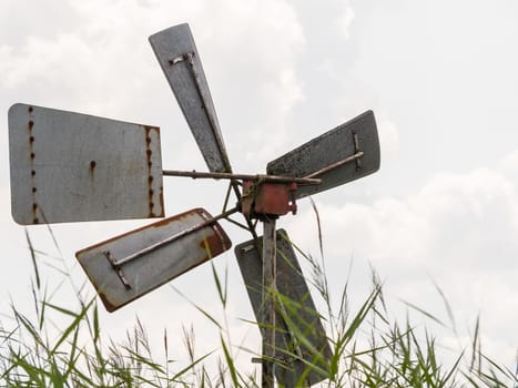 Old rusty windmill in Weerribben, Netherlands, against cloudy sky