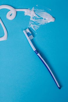 Healthcare. Toothbrush with toothpaste on a blue background
