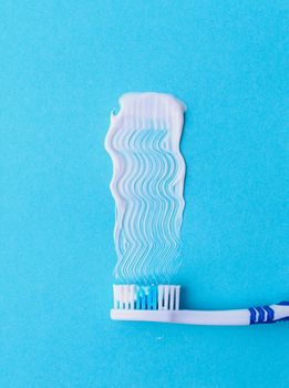 Healthcare. Toothbrush with toothpaste on a blue background