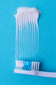 Healthcare. Toothbrush with toothpaste on a blue background